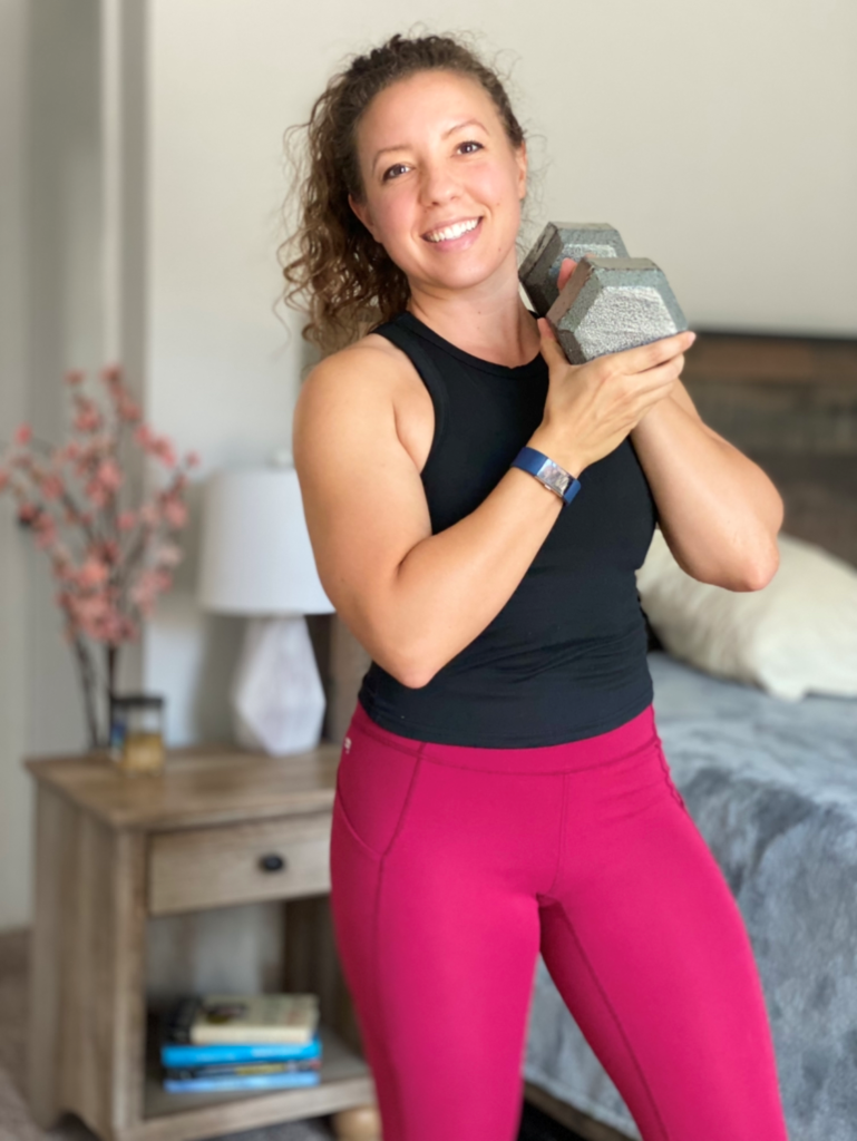 Coach Kristin holding a dumbbell.